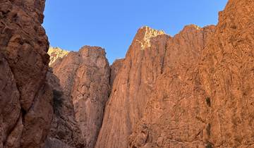 Todra Gorge with high cliff walls and clear blue sky.