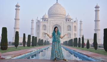 Woman in traditional attire in front of the Taj Mahal.