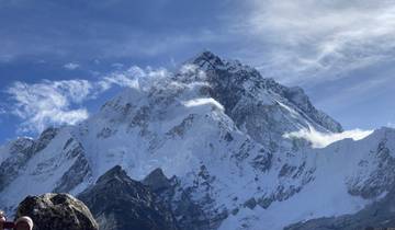 Close-up view of a snow-covered mountain peak against a clear sky.