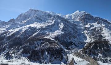 Snow-covered mountains under a clear blue sky.