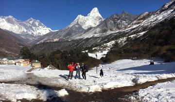 Hikers in snowy landscape with majestic mountains in the background.