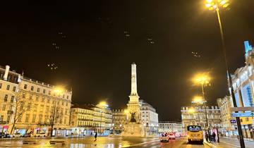 City square and monument lit up at night.