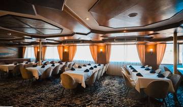 A tastefully decorated dining room with large windows.