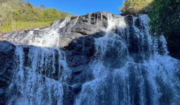 Waterfall over black rock formations.