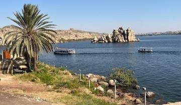 River scene with boats and rocky monoliths.