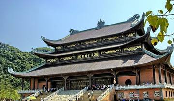 Temple with intricate architecture and people gathered outside.
