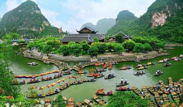 Colorful boats and people in a vibrant festival setting.