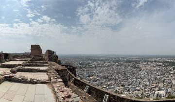 View over a cityscape with ruins in the foreground.