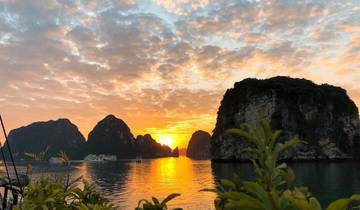 Sunset with vibrant sky and calm water reflections.