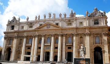 Historic building with statues and a crowd in front