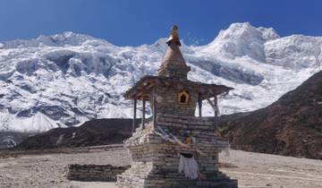 Stone stupa with snowy mountains in the background