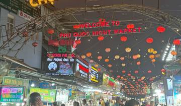 Busy night market with colorful lanterns and signs in Phu Quoc.