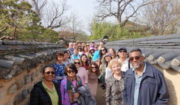Group of tourists walking through a traditional alleyway.