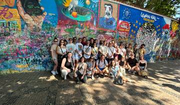 Group gathered by a vibrant graffiti-covered wall.