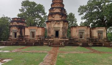 Ancient temple ruins with trees in the background.