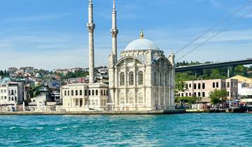Ortaköy Mosque with a bridge in the background, located on the waterfront.