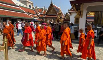 Buddhist monks walking through a temple courtyard.