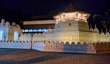 Sacred temple at night, illuminated and showcasing white architecture.