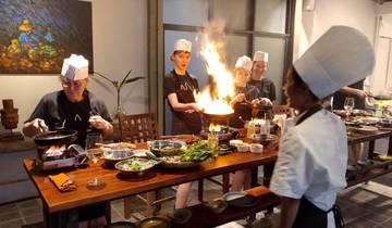 People enjoying a cooking class indoors with flames