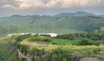Scenic view of a crater lake surrounded by lush hills.