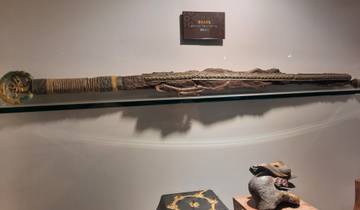 A historical sword displayed in a museum environment with subdued lightning.