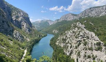Scenic river view with mountains and clear skies.