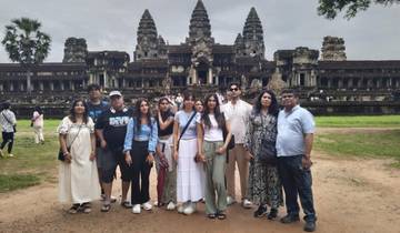Group of people posing in front of the Angkor Wat temple.
