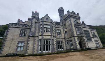 Castle view with stone facade and cloudy sky.