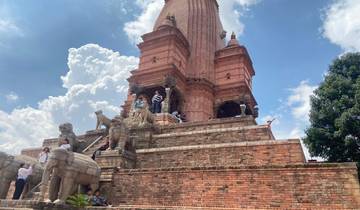 A large temple structure with visitors climbing its steps.