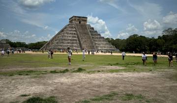Chichen Itza pyramid with many tourists around.