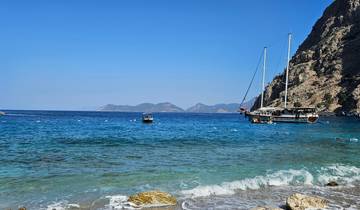 Coastal view with boats and clear blue water.