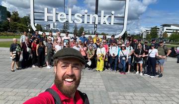 Group of people posing in front of a large Helsinki sign.