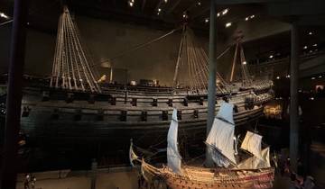 Interior of museum with historic ships in exhibition.