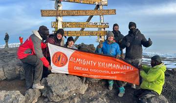Group celebrating at Uhuru Peak, Mount Kilimanjaro.