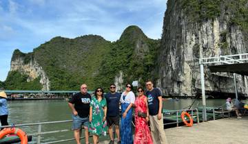 Group of people posing with large rock formations in the background.