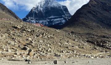 Mountainous landscape with snow on peaks and rocky terrain.