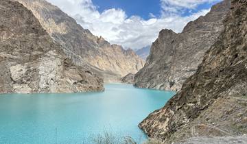 Turquoise lake surrounded by rocky mountains.