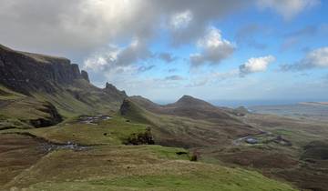 A picturesque view of rolling hills leading to the sea.