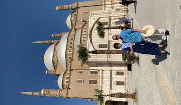 Two people posing in front of a monumental building.