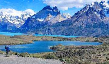Beautiful mountain landscape with a lake and a person taking photos.