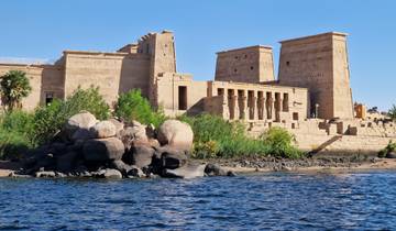 Ancient Egyptian temple by a riverbank.