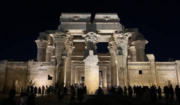 Night view of a well-lit ancient Egyptian temple.