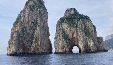 Faraglioni rock formations emerging from the sea.