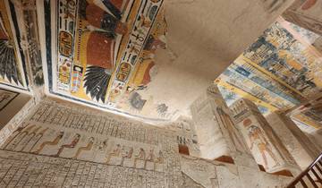 Colorful decorated walls and ceiling inside an ancient tomb.