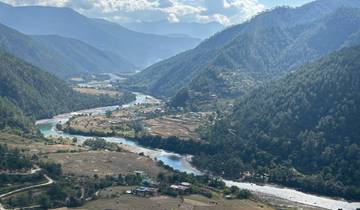 River winding through valley surrounded by mountains.
