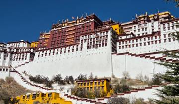 A grand view of a historic palace with white and red details.