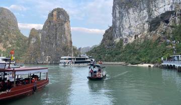 Boats on the water with limestone karsts in the background.