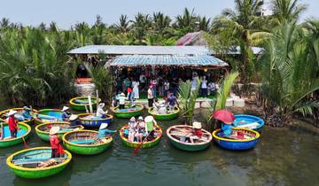 Group of people in colorful round boats on a river.