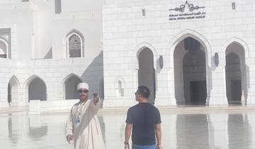 People in front of a grand white building, engaging in conversation.