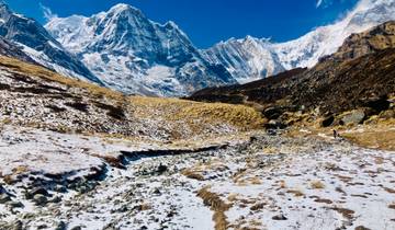 A snowy mountainous landscape with a valley.